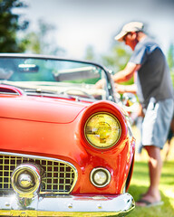Vintage American convertible classic car on display at outdoor show.