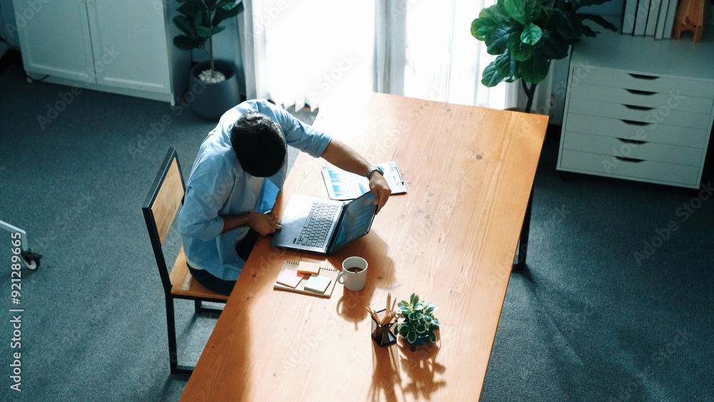 Poster top view of business man working on laptop while looking at financial chart. manager with casual clo