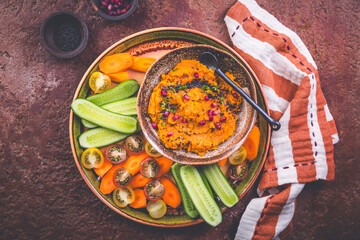 Spicy carrot spread, dip, hummus with raw snack vegetables