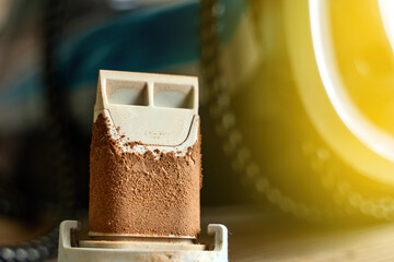 steam iron's scale collector, heavily encrusted with mineral deposits. It highlights the...
