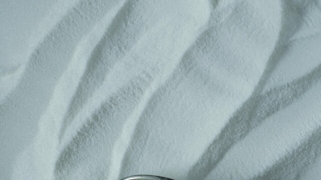 Texture of powder food additive E316, close-up. Sodium erythorbate or isoascorbate powder used in food industry, predominantly in meats, poultry, and soft drinks.
