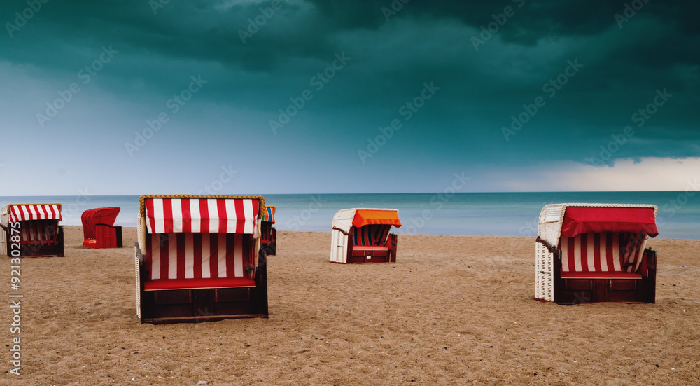 Poster a beach with several beach chairs and umbrellas