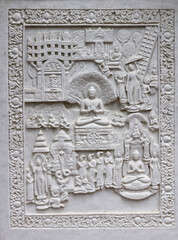 Decorative marble carving on the wall of a Buddhist temple in Lumbini. A scene from the life of Buddha.