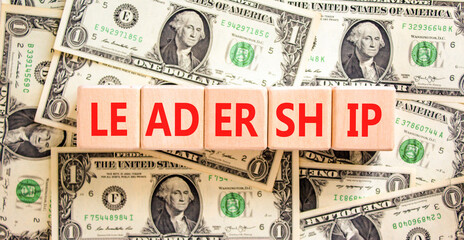 Leadership symbol. Concept word Leadership on beautiful wooden blocks. Dollar bills. Beautiful...