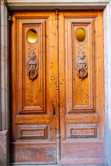 Wooden door with carved male faces, Gothic Quarter,  Barcelona, Catalonia, Spain, Europe