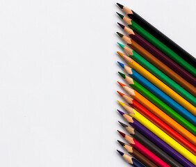 Back to school. Colored pencils on a white background. Space for text