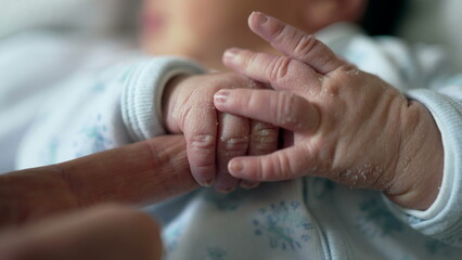 Newborn baby's hand grasping an adult's finger, highlighting the strong bond and connection between parent and child, emphasizing trust, security, and the tender moments of early life
