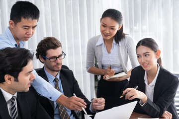 Diverse of business people from various ethnic group working in modern office environment. Productive and multi ethnic office workers engage in discussion for strategic business marketing. Meticulous