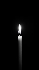 Fototapeta premium A single candle burns brightly, illuminating the surrounding darkness gently