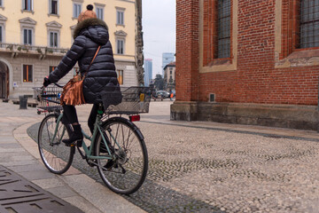 Woman on a bicycle in the center of Milan