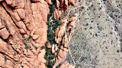 Aerial top view shot of natural red rocks composition in Nevada desert 