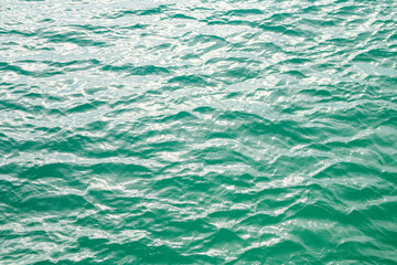 Green ocean water. Background water wave. Background of ocean surface. Background texture. Water in swimming pool or sea. Rippled water texture.