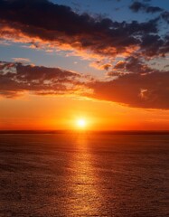 Fototapeta premium Sunrise or Sunset: A horizon scene with the sun rising or setting, providing a large area of sky for adding text or showcasing products against a beautiful backdrop