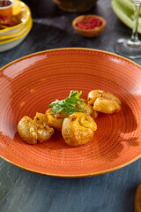 Smashed and Baked Baby Potatoes Garnished with Fresh Herbs on Rustic Plate