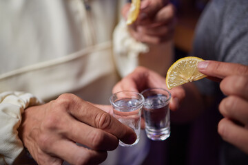 Heres to Good Times A Group of Friends Joyfully Enjoying Shots with Fresh Lemon Slices