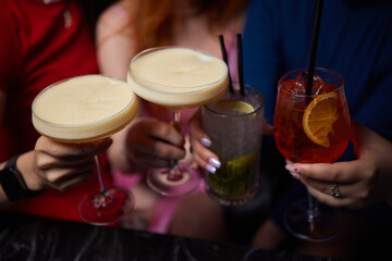 Cheers to the Night A Joyful Celebration with Cocktails in a Colorful Bar Atmosphere
