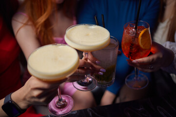 Cheers to the Night A Joyful Celebration with Cocktails in a Colorful Bar Atmosphere