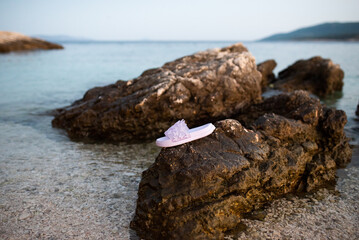 purple slippers with butterflies, on the sea