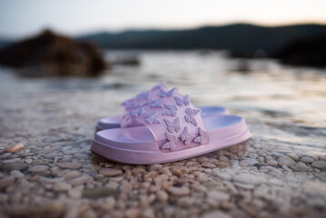purple slippers with butterflies, on the sea