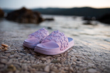 purple slippers with butterflies, on the sea