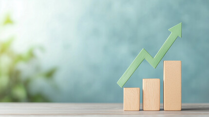 Green arrow on a bar chart rising against a blue background, symbolizing business growth and positive trends. Photo