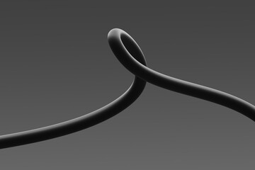 A close-up view of a looped black cable against a grey background