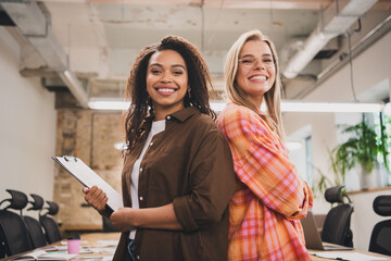 Photo of two young corporate businesswomen coworking loft interior office indoors