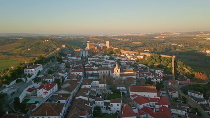 Panoramic view old town with ancient castle walls at evening light aerial shot