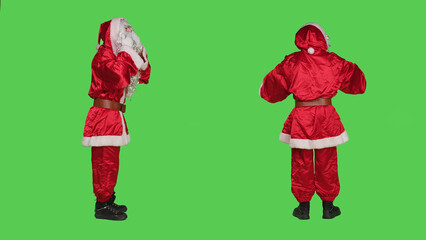 Sweet saint nick giving air kisses over full body greenscreen background, acting romantic and flirty in studio. Santa claus expressing romance gesture, spreading christmas holiday spirit.