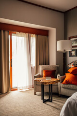 modern hotel room with open balcony door with billowing curtain