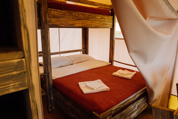 Interior of cozy open glamping tent. Camping tent for outdoor summer holiday and vacation