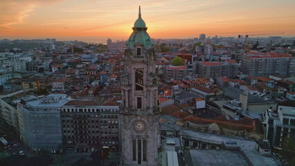 Obraz premium Drone historic town evening on sunset. Old clock tower in city center evening