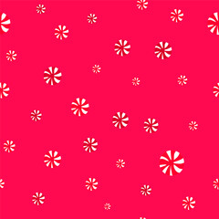 Seamless confetti pattern of red candies on a red background.