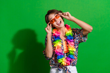 Photo of funky woman dressed print blouse colorful necklace touch sunglass staring at offer empty space isolated on green color background