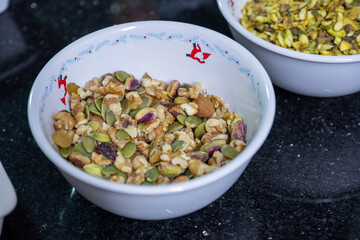 Two bowls filled with a festive mix of nuts and dried fruits, capturing the essence of Christmas treats. Pistachios, walnuts, and cranberries come together in a delicious holiday snack assortment