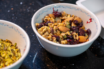 Two bowls filled with a festive mix of nuts and dried fruits, capturing the essence of Christmas treats. Pistachios, walnuts, and cranberries come together in a delicious holiday snack assortment