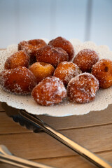 Close-up of sugared donut holes on a plate