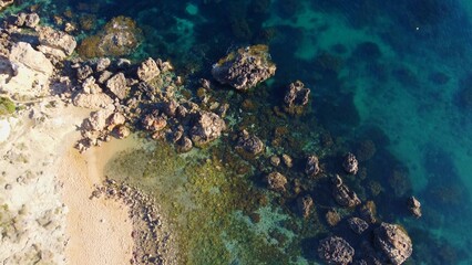 Rocky beach and sapphire sea water on the Maltese island, mediterranean sea, Ghajn Tuffieha bay , Malta. High quality photo