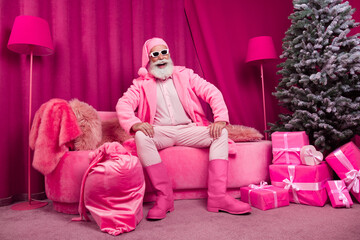 Photo of pensioner bearded male santa claus sit sofa fancy boots fur coat fluffy nighty hat cool...