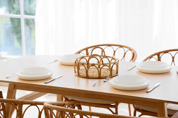 Set of tableware in interior of dining room