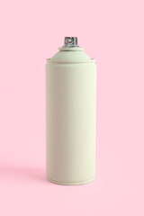 Spray paint can on pink background