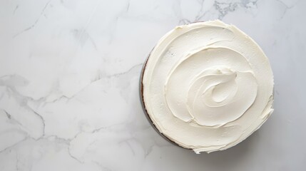 Classic white cake with buttercream frosting is sitting on a marble background, making a delicious and elegant dessert