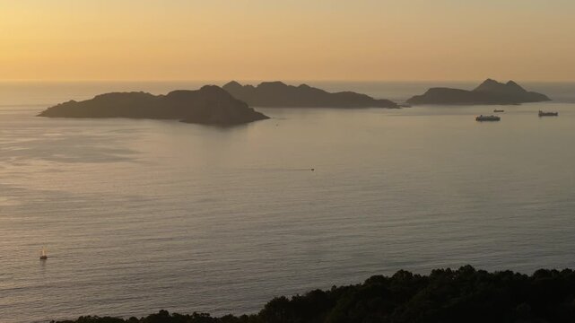 Aerial shot of a tranquil seascape and islands at sunset in Nigran, Spain.