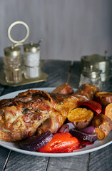 Roast turkey drumstick with roasted vegetables.