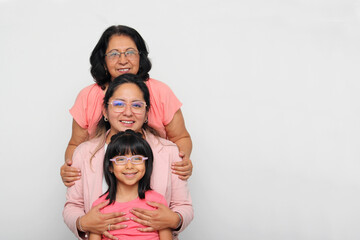 Grandmother, mom and daughter, three generations of dark-skinned Latina women show the importance of ancestors and female lineage on Mother's Day