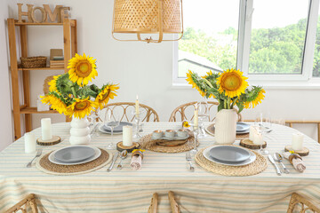 Vases with beautiful sunflowers on dining table
