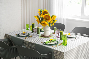 Served table with sunflowers in dining room