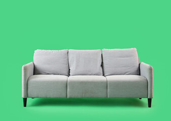 Grey sofa on green background