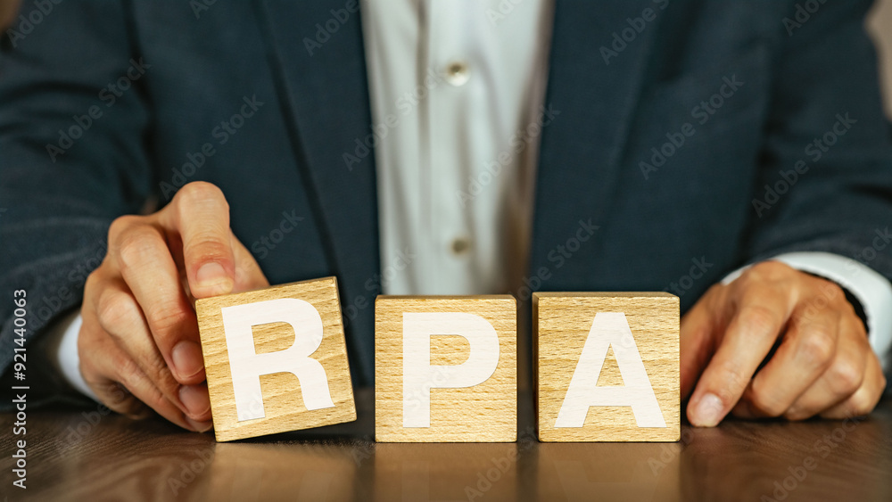 Poster there is wood cube with the word rpa. it is an abbreviation for robotic process automation as eye-ca
