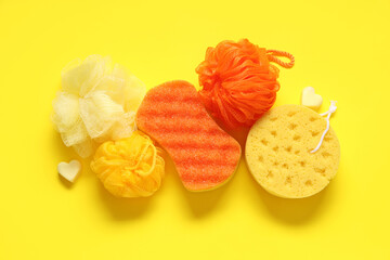 Composition with different bath sponges on yellow background